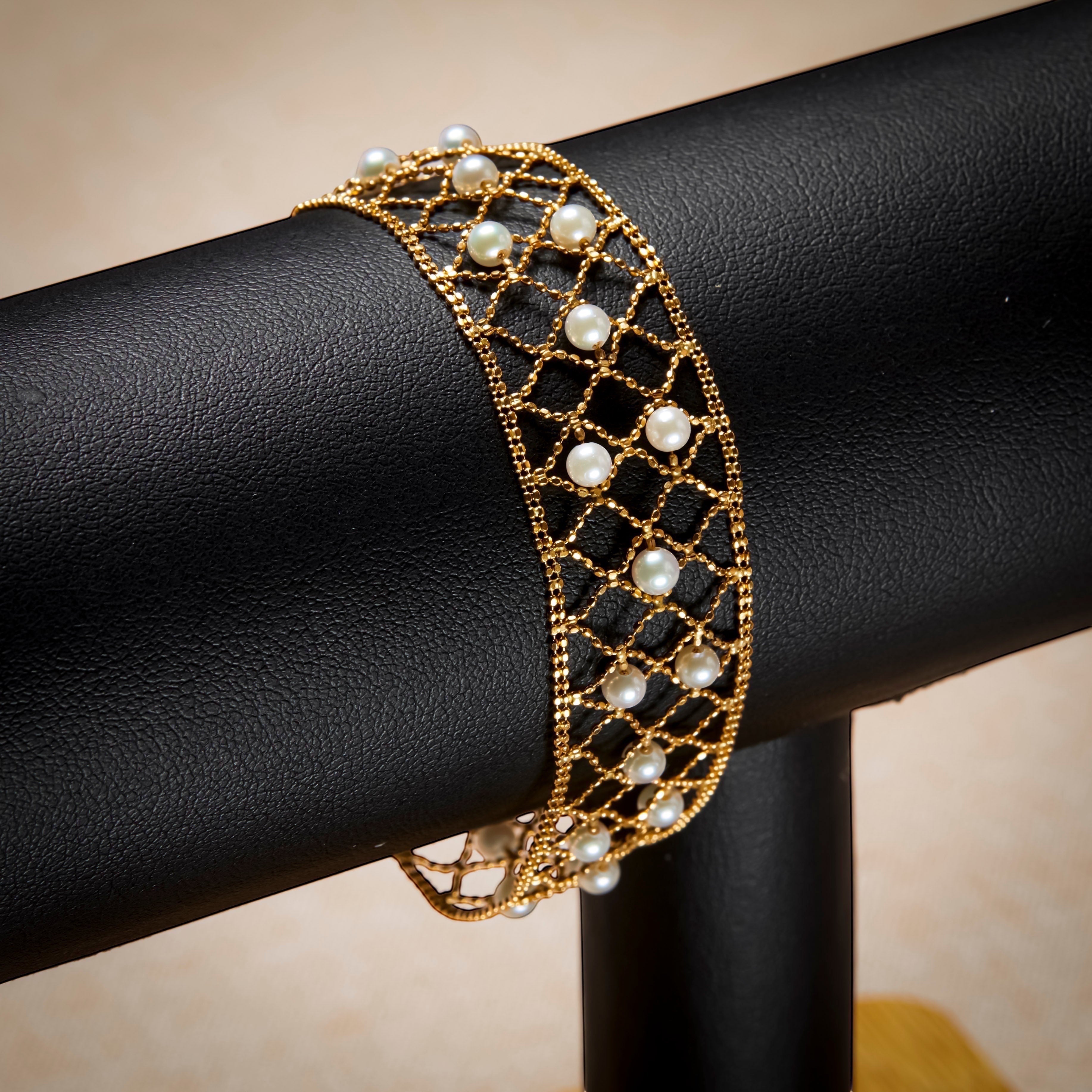 BoxUnboxed 18k yellow gold lace lattice bracelet with Akoya pearls. Features a flexible, woven gold design with small, round pearls.
