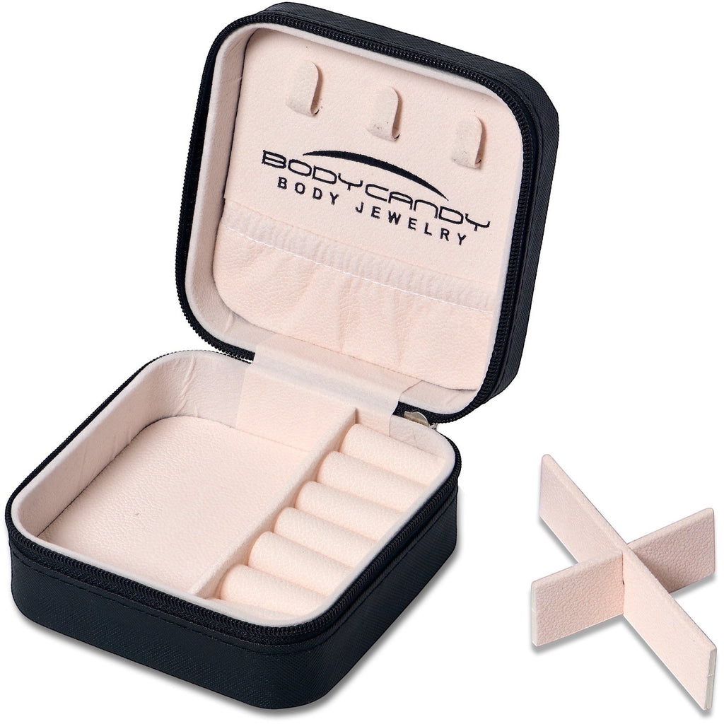 BoxUnboxed black travel jewelry organizer with soft pink interior, ring rolls, and earring slots.