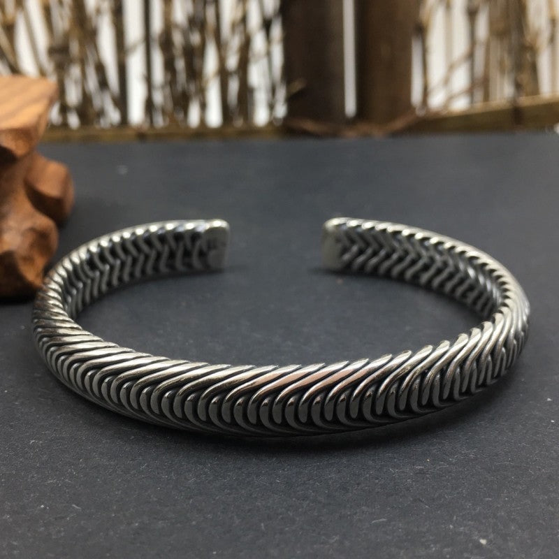 BoxUnboxed Nordic Frost Artisan Braided Silver Cuff. Solid 925 sterling silver, 35g, open cuff style with intricate braided texture and polished borders.