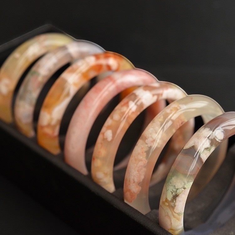 BoxUnboxed Natural Flower Agate Sakura Bangles with delicate pink and white floral inclusions resembling cherry blossoms.