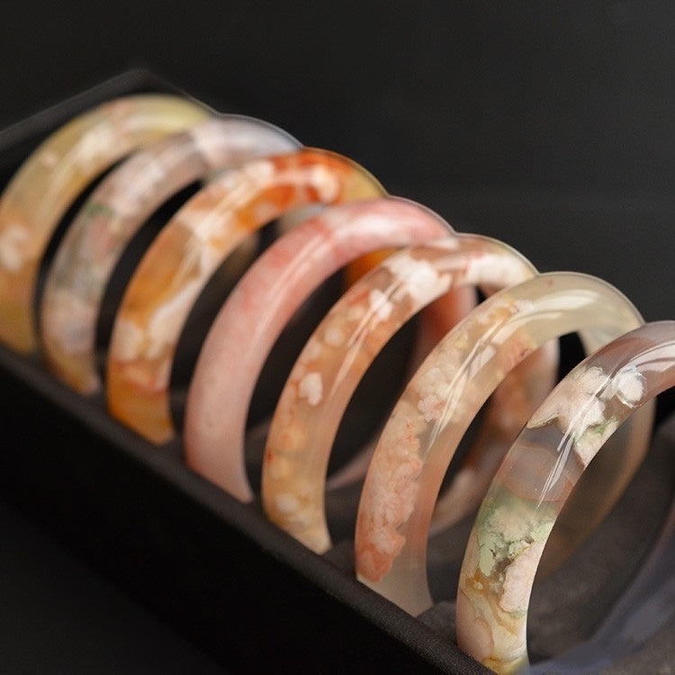 BoxUnboxed Natural Flower Agate Sakura Bangles with delicate pink and white floral inclusions resembling cherry blossoms.