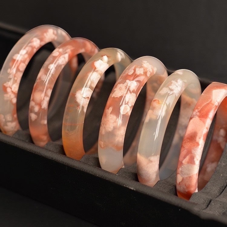 BoxUnboxed Natural Flower Agate Sakura Bangles with delicate pink floral inclusions in clear and orange agate.
