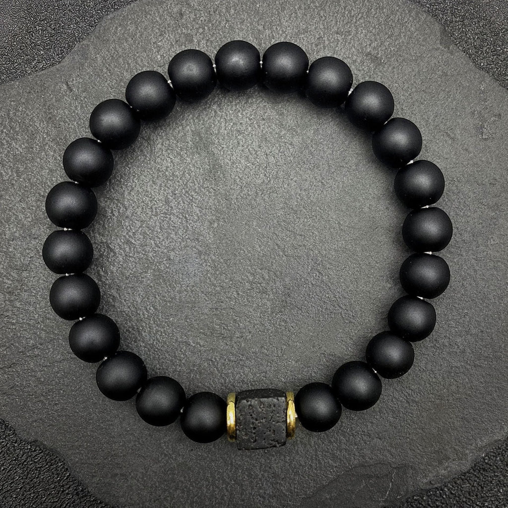 BoxUnboxed Obsidian & Volcanic Stone Stack Bracelet with matte black beads and a single textured lava stone accent.